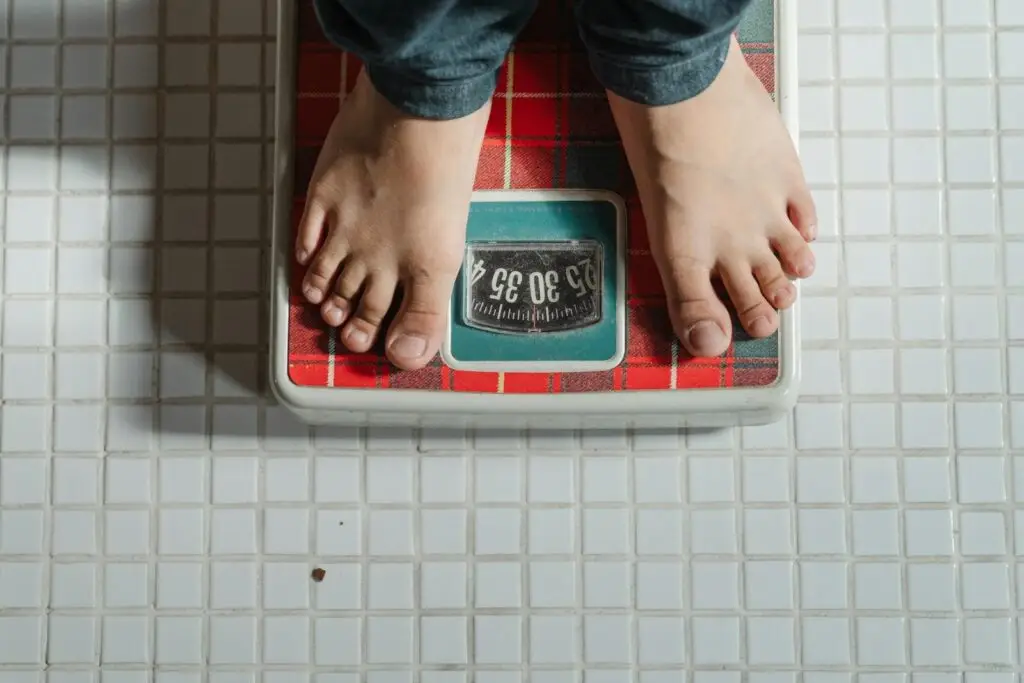 are mushrooms good for weight loss. mushrooms. weight loss From above crop anonymous barefoot child in jeans standing on weigh scales on tiled floor of bathroom